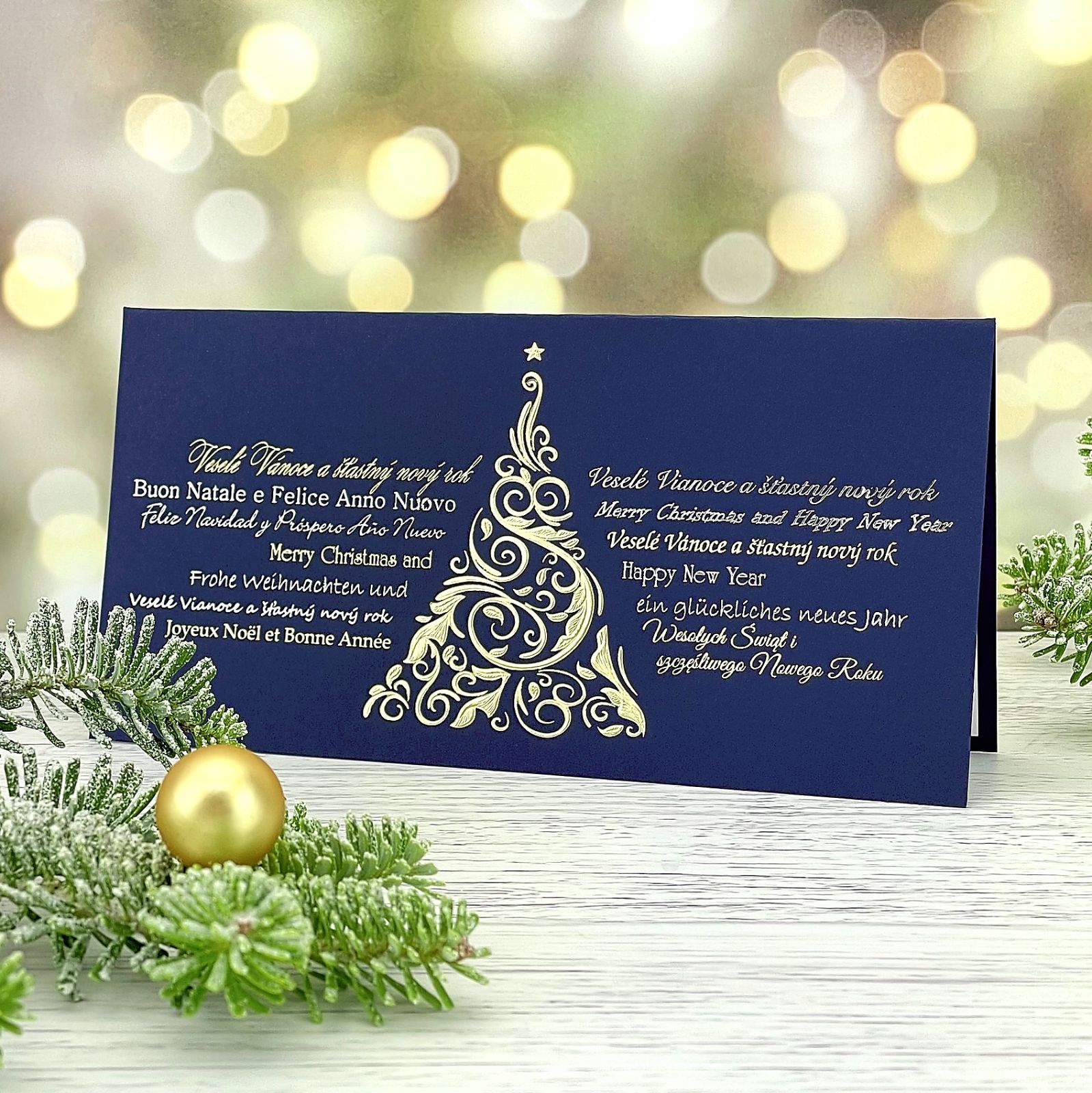 Novoroční–vánoční přání z modrého grafického papíru s motivem zlatého vánočního stromu, otevírací, formát 200 × 100 mm.
