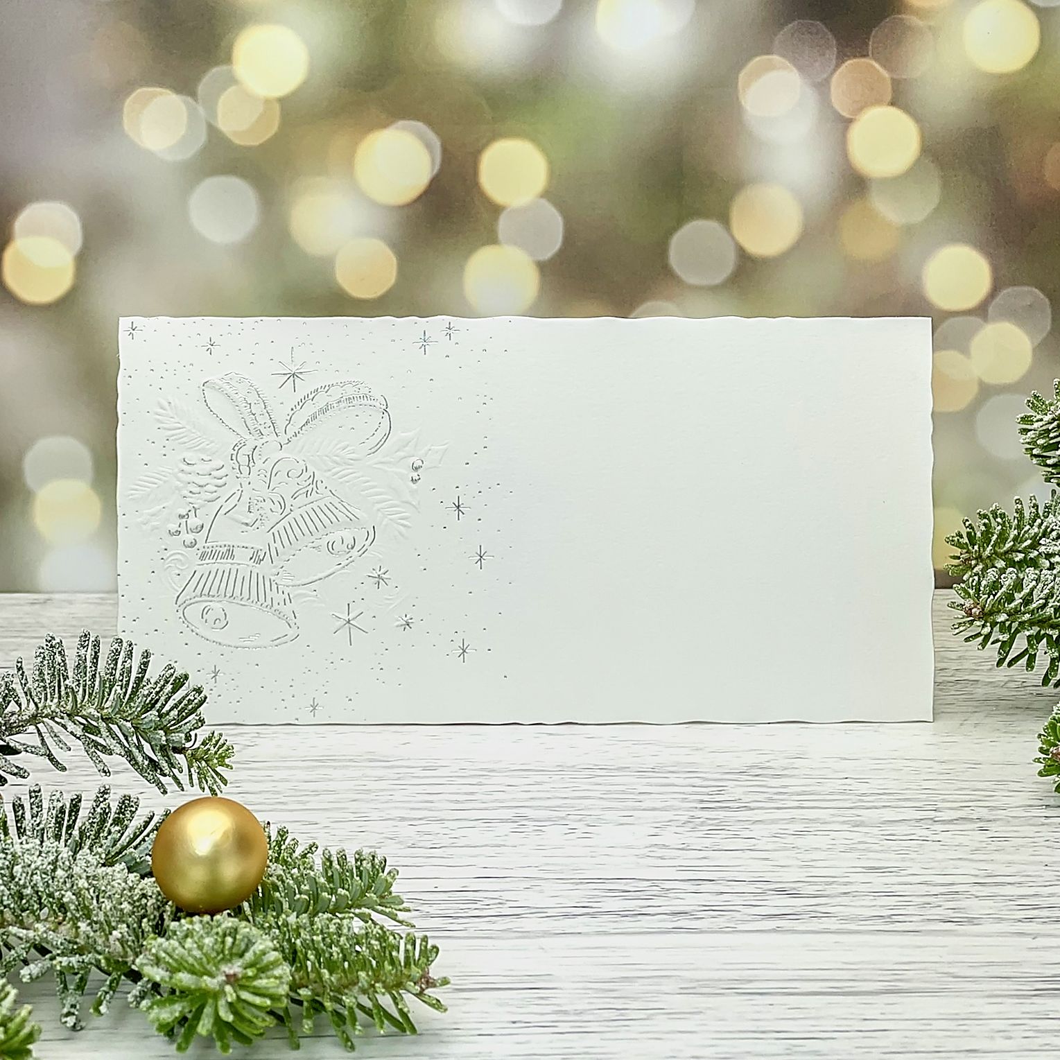Novoroční–vánoční přání s motivem vánočních zvonků, z bílého grafického papíru, jednoduchá karta, formát 200 × 100 mm
